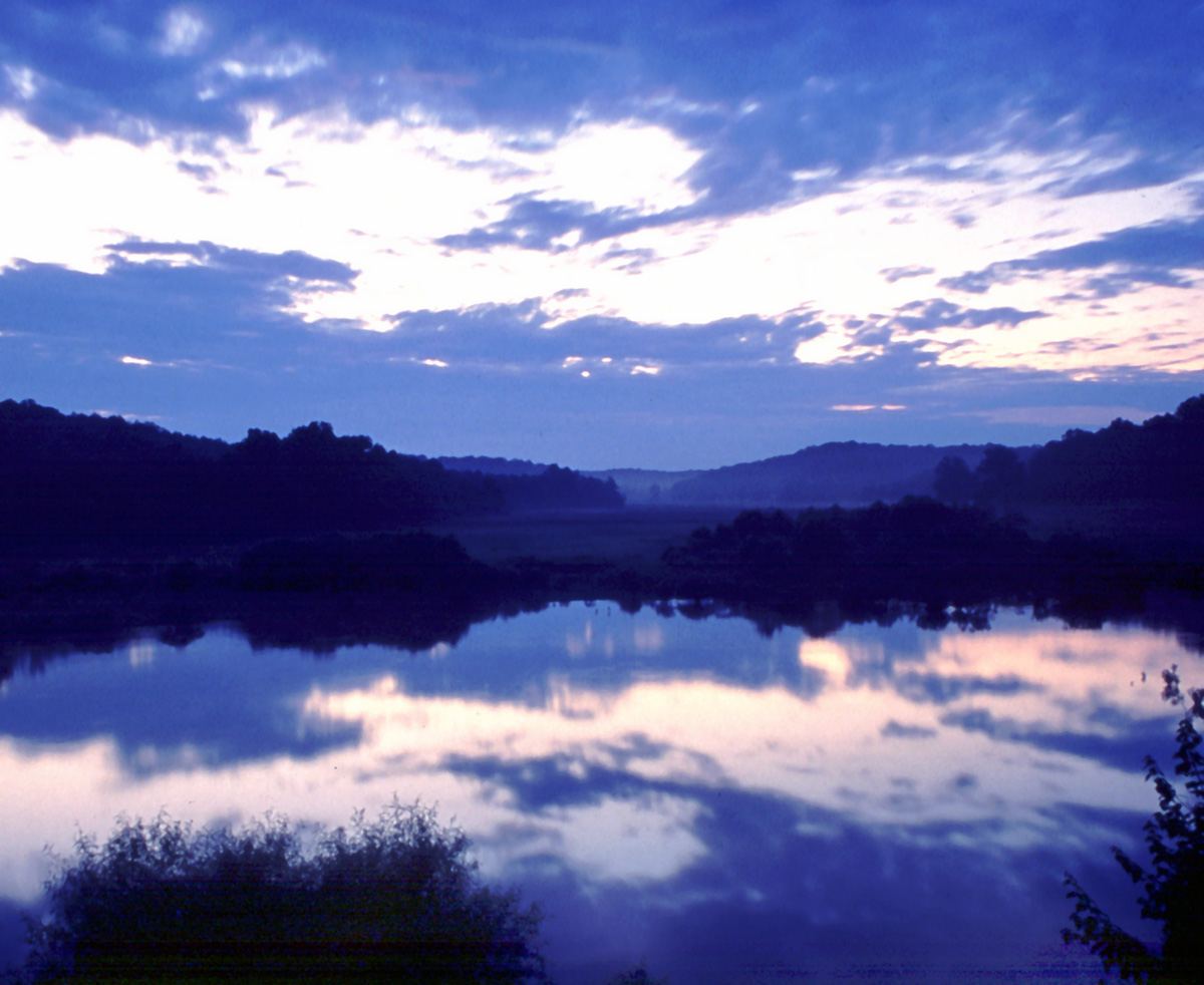 Clouds reflected in a still lake at Land Between the Lakes